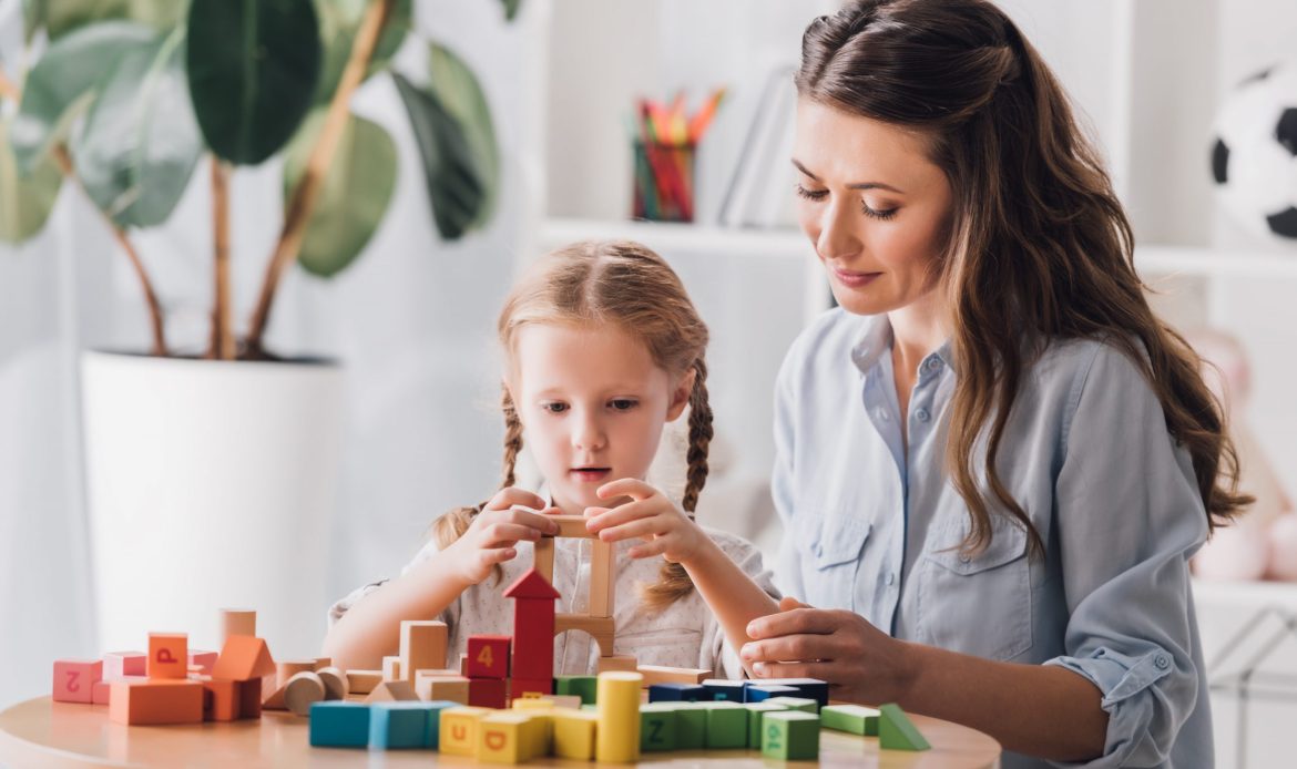 psychologist-playing-blocks-with-little-child-with-2021-08-30-02-05-51-utc-scaled
